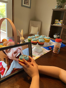 My daughter feeding my brother a cupcake during his virtual birthday party