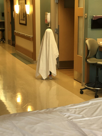 My daughter pretending to be a ghost at the hospital Probably a poor choice