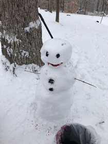 My kids snowman looks like it ate a small woodland critter and enjoyed it