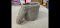 My son  took a pottery class this summer and made this super awesome mug The handle is a thumb he says