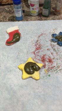 My sons solution of mixing all the left over icing together and then what they did with the final color Merry Sh_tmas