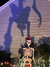 Neighbors added some ornaments to my  tall skeleton