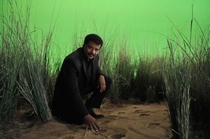 Neil deGrasse kneeling in de grass Ill see myself out