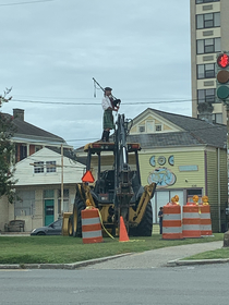 Not everyday you see a bagpiper on construction equipment stay weird New Orleans