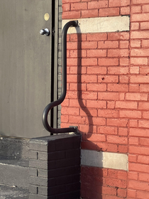 Once a day the sun casts a perfect shadow on this railing