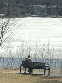 Only in MN will you find a shirtless Sun basker shoreside a mostly frozen lake