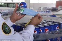 Pic #2 - CAN-ouflage Smuggler caught trying to sneak  cans of beer into Saudi Arabia by disguising them as PEPSI