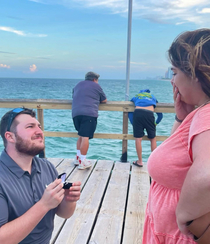 Proposed to my girlfriend yesterday and just noticed the guy in the back is not having a good time 