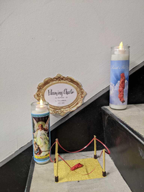 Saw this on my way up the stairs at work today A Cheeto has been laying on the same stair for  weeks Now there is a shrine to it