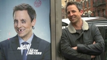 Seth Meyers next to his defaced face
