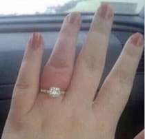 She may have said yes but her finger is screaming no