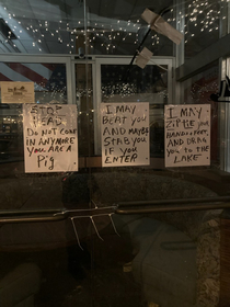 Shop owner in Asbury Park NJ tapes a sample zip tie to window to bring reality to his threats