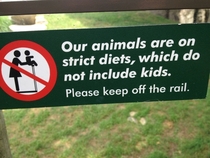 Sign in front of the lion exhibit at the zoo