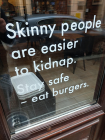 Sign on a window of a burger joint in Krakow Poland