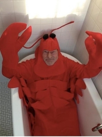 Sir Patrick Stewart dressed as a lobster and lounging in a tub