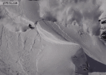 Skier outrunning an avalanche does a backflip