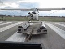 Small aircraft using a truck to takeoff