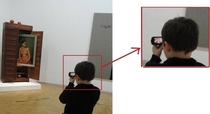 Sneaky Kid taking pictures at a museum
