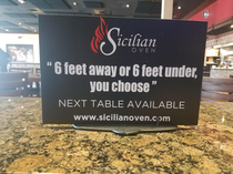 Social distancing signs at an Italian restaurant in South Florida
