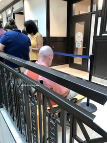 Standing in line at the DMV just to get into the offices waiting room and this guy had the foresight to bring a lawn chair Hes just been sliding it along with his feet as the line slowly advances 