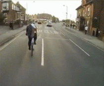 Taking off his jacket while riding a bike