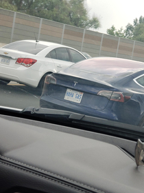 Tesla driver with a perfect license plate