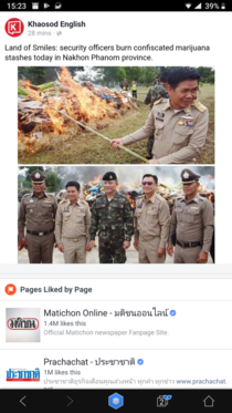 Thai officers diligently burning confiscated weed