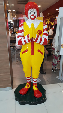 Thai Ronald McDonald looks like he is praying to the Lord for forgiveness before he goes on a ravenous murder spree