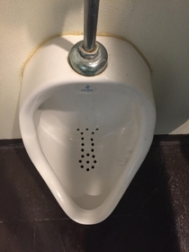 The drain holes in this urinal