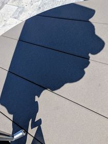 The shadow of this umbrella looks like a little man with a giant head