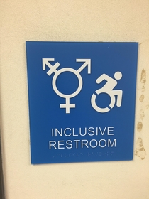 This bathroom sign at my college looks like a handicapped man running from a transgender