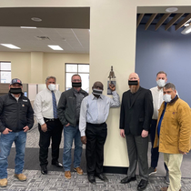 This construction company photoshopped masks on their employees in a photo to celebrate the completion of a new dormitory building at UNCSA