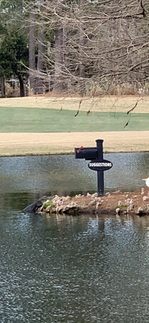 This golf courses suggestion boxon an islandwith a guard or  on duty  