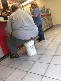 This guy brought a bucket into Papa Johns to sit on while waiting