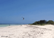 This guy is a total badass Kite surfer jumps over island