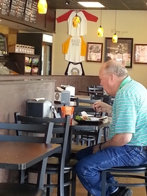 This guy is using an iPhone to prop up a Galaxy to watch Netflix out loud in a restaurant I can only dream of giving this few fucks