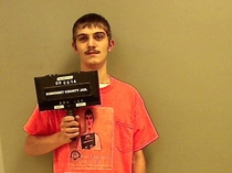 This guy was arrested for driving without a license He was also wearing a T-shirt with his last mugshot on it