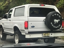 This license plate on a white Ford Bronco