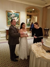 This photo of our wedding coordinator holding our cake knife makes her look like a Disney villian