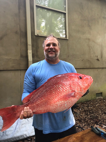 This real picture of my dad with a fish he caught looks photoshopped but it isnt