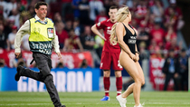 This security guard eagerly chasing a streaking swimsuit model