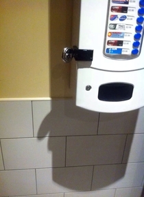 This shadow from a condom machine