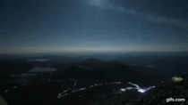 Timelapse of  people with headlamps hiking down a mountain at night