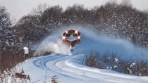 Train plowing through snow