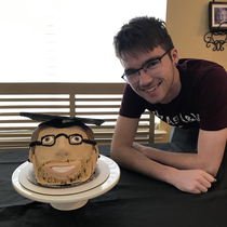 Tried to make my brothers face into his graduation cake