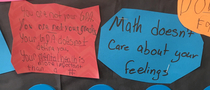 Two students with different messages on a math teachers class tips board