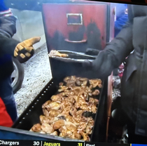 Watching Bills fans cooking meat in a filing cabinet