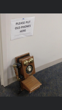 We upgraded our phone system at work and got new phones All the old phones were supposed to be left in the hallway under this sign Someone brought in this