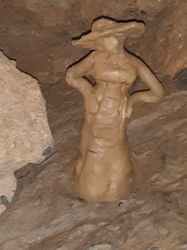 Went to a cavern and someone made a Lady Dimitrescu out of clay from the cave
