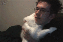 White cat doesnt want to stop hugging a Clay Aiken lookalike